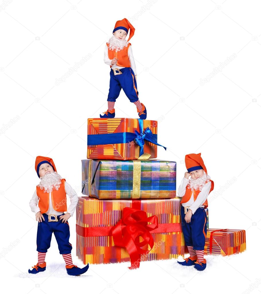 Three posing gnomes with gift boxes