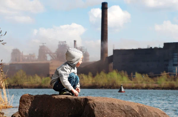 Industrial landscape with playing boy — Stock Photo, Image