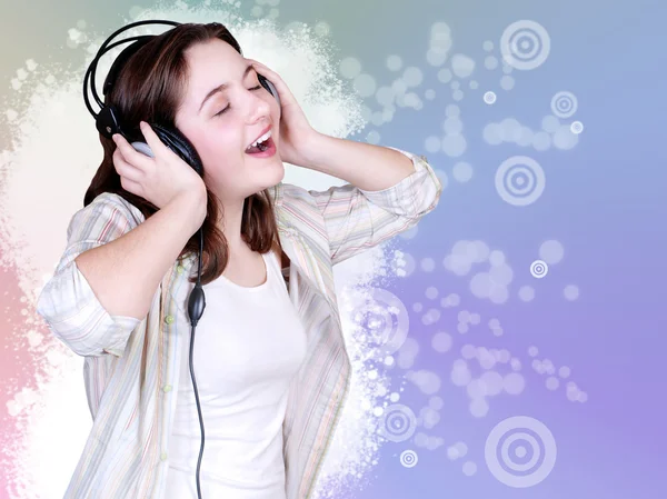 Portrait of singing cute teenage girl in headphones — Stock Photo, Image