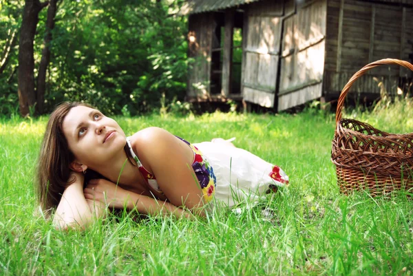 Молодая женщина лежит на зеленом лугу — стоковое фото