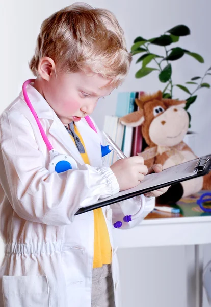 Little doctor with clip board — Stock Photo, Image