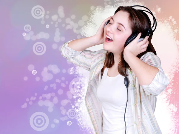 Portrait of singing cute teenage girl in headphones — Stock Photo, Image