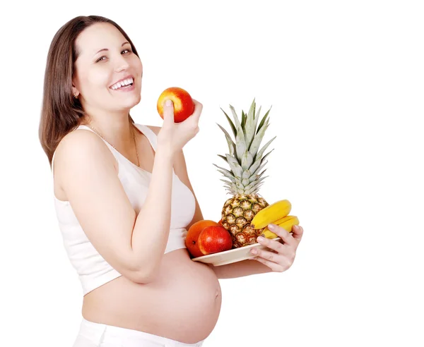 Meyve ile mutlu gülümseyen hamile kadın — Stok fotoğraf