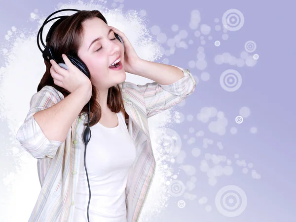 Portrait of singing cute teenage girl in headphones — Stock Photo, Image