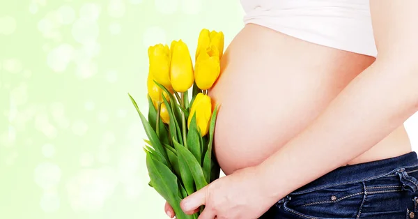 Femme enceinte ventre avec des tulipes — Photo