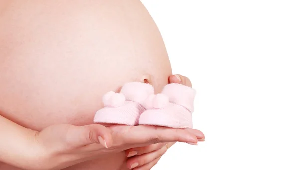 Mani femminili con stivaletti del bambino — Foto Stock