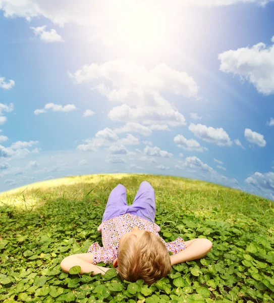 Lying on green grass carefree boy — Stock Photo, Image