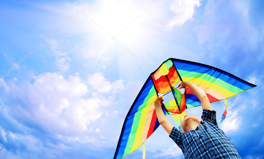 Happy child flies a kite in the sky