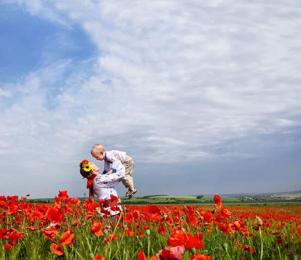 Mother and son on the poppies field