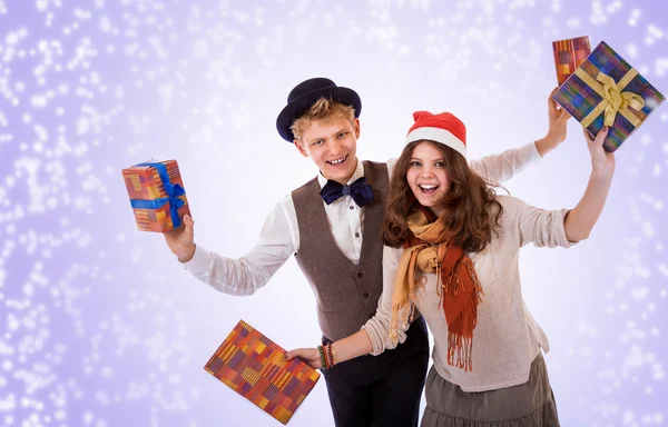 Teenage boy and girl with christmas presents — Stock Photo, Image