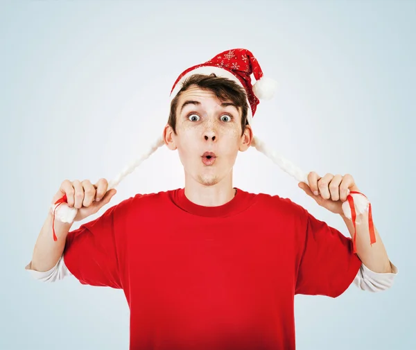 Young man in funny santa hat with pigtails — Stock Photo, Image