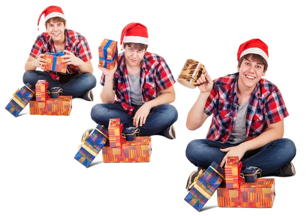 Cheerful young man dressed in santa hat found gift in box — Stock Photo, Image