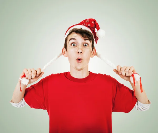 Young man in funny santa hat with pigtails — Stock Photo, Image