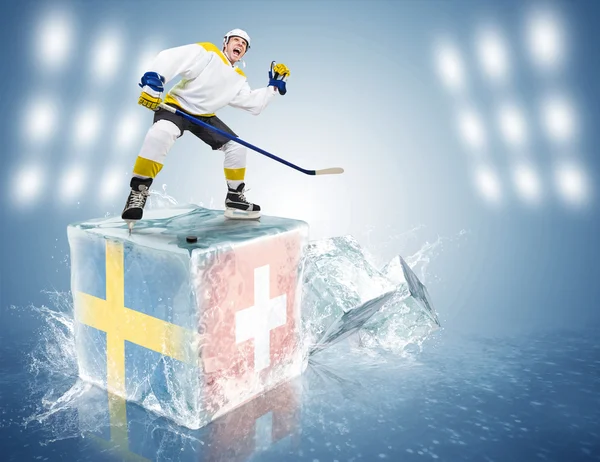 Sweden - Switzerland game. Spunky hockey player on ice cube — Stock Photo, Image