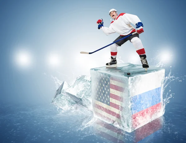 USA - Russia game. Spunky hockey player on ice cube — Stock Photo, Image