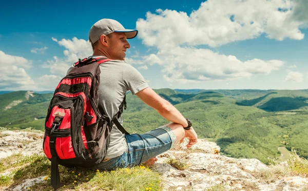 Mountain hiker relax on the top of mountain