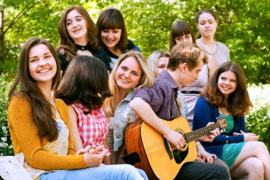 Kızlar için gitar tarafından terennüm genç çocuk