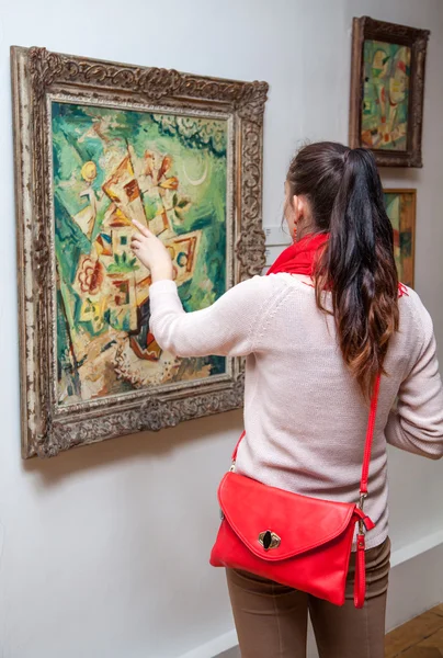 Girl looking at Fulla's painting, Slovakia — Stock Photo, Image