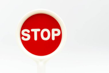 Beyaz arkaplandaki kırmızı trafik işaretinde dur metni.