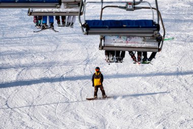 VALCA, SLOVAKIA - 22 HAZİRAN 2022: Dağ tatil köyündeki yamaçta oturan insanlar ve snowboardcular. Dağ tatil beldesi SNowland 'da