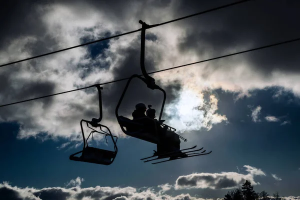 Silhouette Skiers Sitting Ski Lift Chairs Sky — Stock Photo, Image