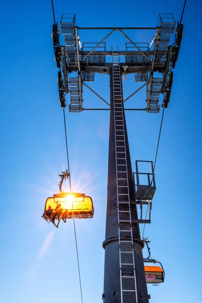 Skieurs Assis Télésiège Mât Téléphérique Sur Fond Ciel Bleu — Photo