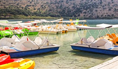 KOURNAS, GREECE - SEPTEMBER 7, 2013: Paddle boat on lake Kournas at Crete island in Greece