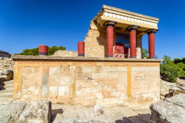 Ancient ruins of Knossos palace with Minoan columns. Largest Bronze Age archaeological site on Crete island, Greece