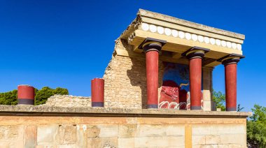 Ancient ruins of Knossos palace with Minoan columns. Largest Bronze Age archaeological site on Crete island, Greece