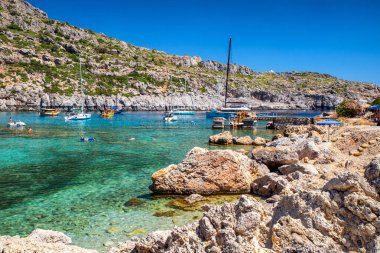 FALIRAKI, GREECE - JULY 4, 2022:Luxurios yachts in Anthony Quinn bay with crystal clear water in Rhodes island, Greece