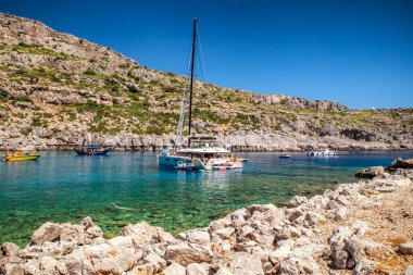 FALIRAKI, GREECE - JULY 4, 2022:Luxurios yachts in Anthony Quinn bay with crystal clear water in Rhodes island, Greece