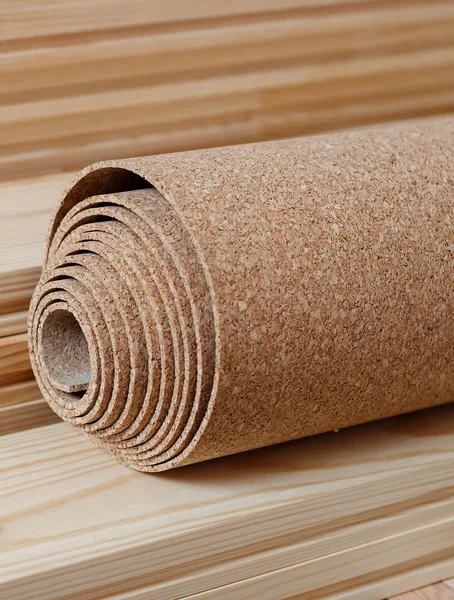 A roll of cork lies on the floor battens — Stock Photo, Image