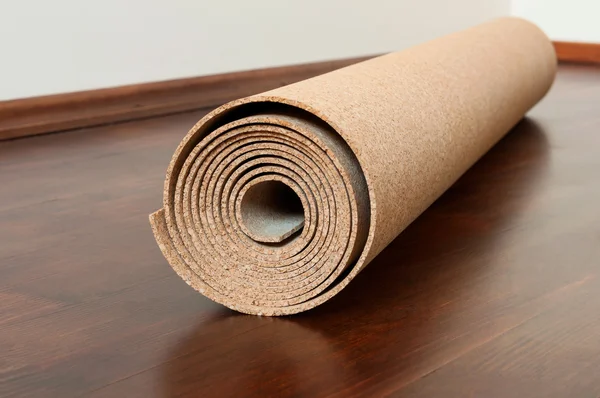 Roll of cork lies on a brown floor — Stock Photo, Image
