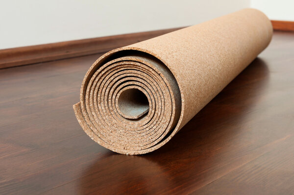 Roll of cork lies on a brown floor