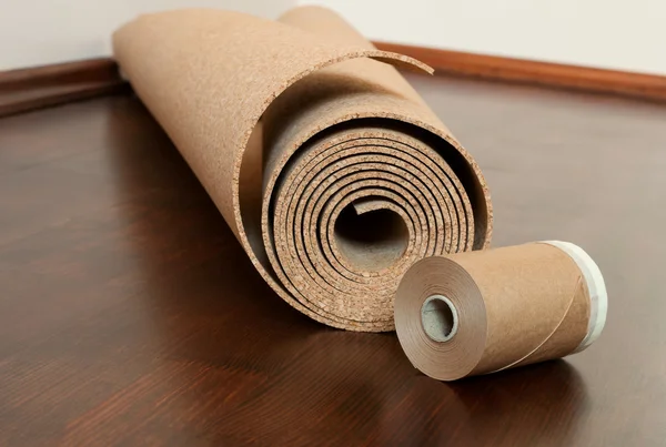 Roll of cork with Painting edging tape on a brown floor — Stock Photo, Image