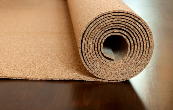 Roll of cork lies on a brown floor — Stock Photo, Image