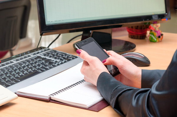 Woman use a mobile phone. Office work