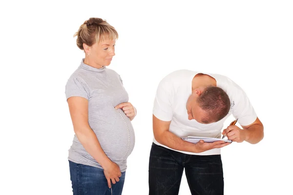 Husband inspects wife's belly — Stock Photo, Image