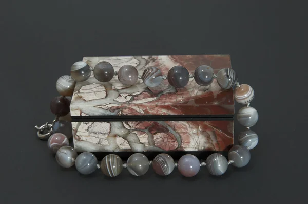 Stone box with the beads. — Stock Photo, Image