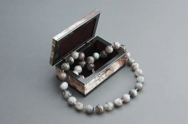 Stone box with the beads. — Stock Photo, Image