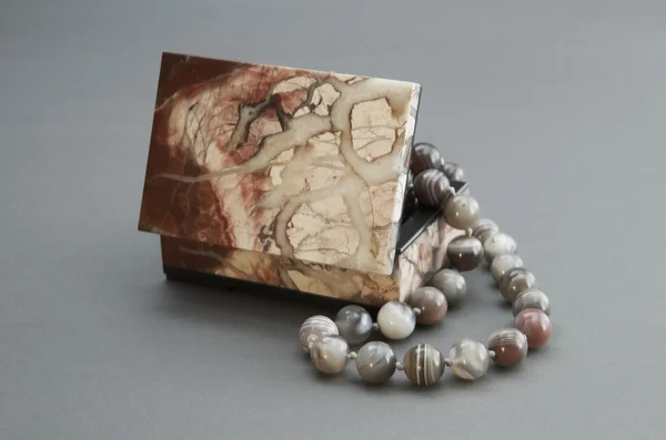 Stone box with the beads. — Stock Photo, Image