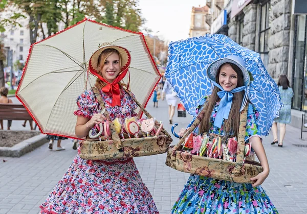 Girls in national costumes sell sweets in Kiev, Ukraine. Stock Picture