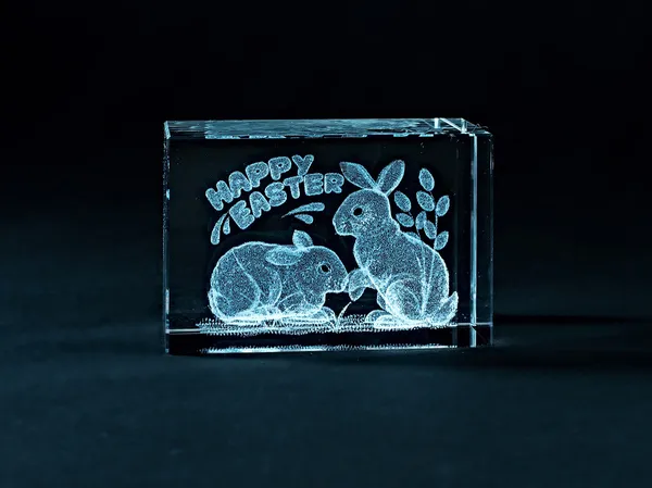 Glass items with volumetric laser engraving. Stock Picture
