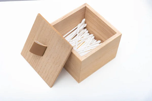 An open wooden box with cotton buds in it, isolated — Stock Photo, Image