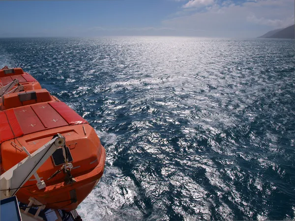 Lifeboat on a ferry, deep blue sea — Stock Photo, Image