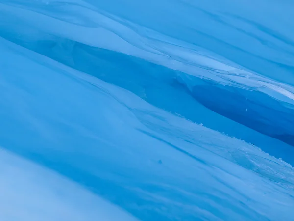 Blue ice cave covered with snow and flooded with light — Stock Photo, Image