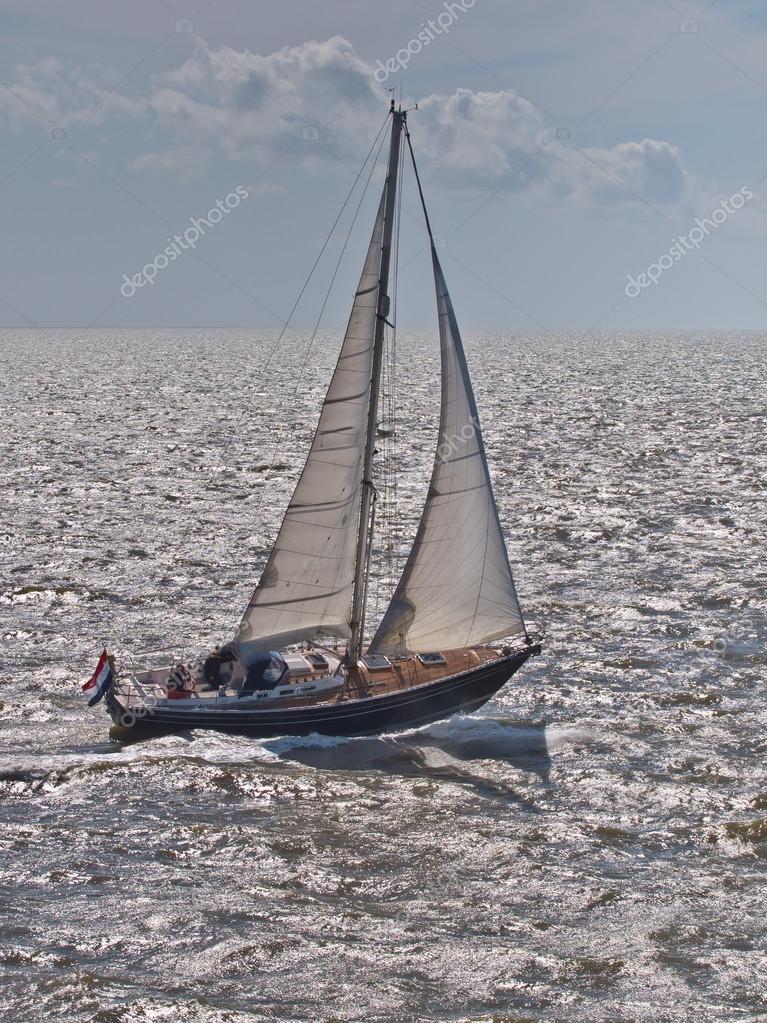 Fast Sailing Boat in Stormy Weather in the Netherlands Stock Photo by