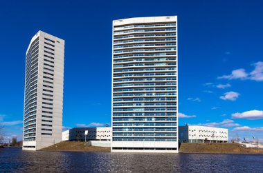 White Apartment Towers at the Water Front with Blue Sky