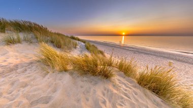 Sunset View over ocean from dune over North Sea and Canal in Ouddorp, Zeeland Province, the Netherlands. Outdoor scene of coast in nature of Europe. clipart