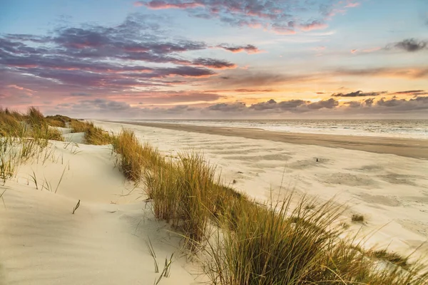 View from dune top over sunset in North Sea from the island of Ameland, Friesland, Netherlands